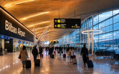 Terminal del aeropuerto de Bilbao con iluminación moderna y viajeros con maletas