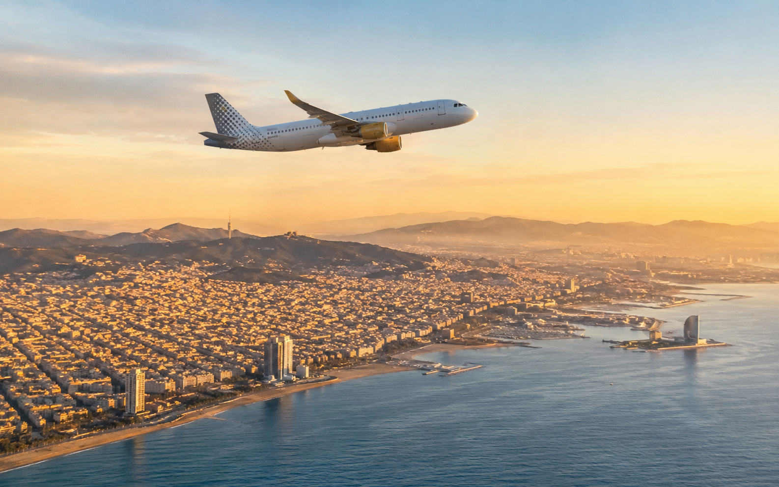 Aerial view of Barcelona coastline with an airplane in flight above the city, golden hour light